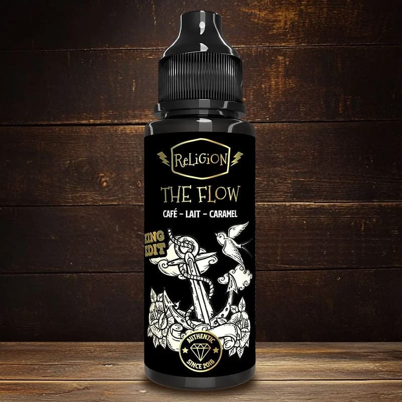 Flacon 100ml d'e-liquide Religion Juice The Flow, étiquette noire avec illustration d'ancre et hirondelle, fond bois rustique.