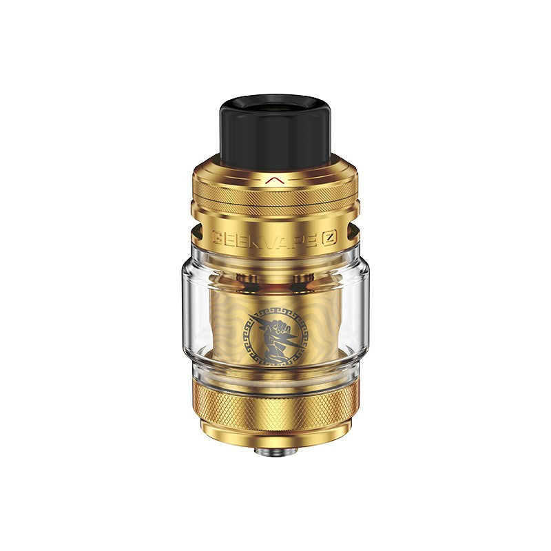 Clearomiseur Geekvape Zeus Sub Ohm doré avec réservoir en pyrex transparent, drip tip noir et logo gravé sur la résistance.