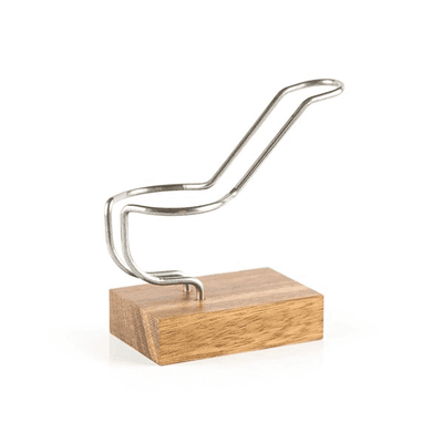 Support artisanal pour e-pipe CREAVAP avec socle en bois naturel et structure incurvée en métal argenté.